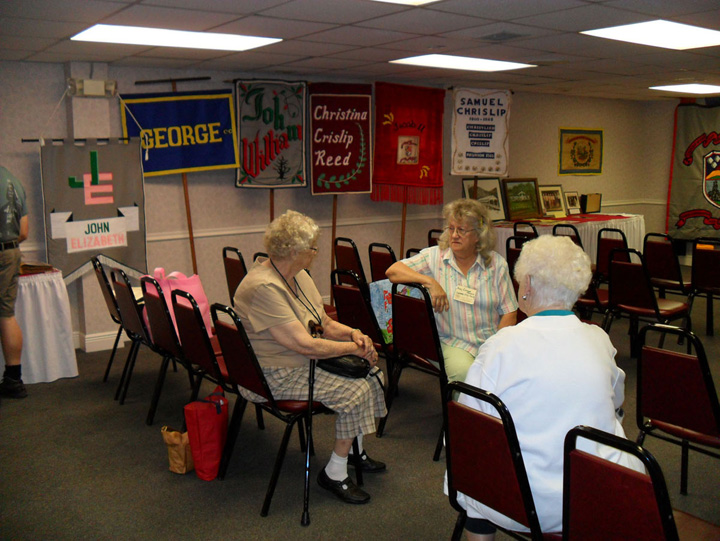 Gathering in the memorabilia room.  Many of the 
							banners representing the different family lines descending from Friedrich Carl may be seen in the background.