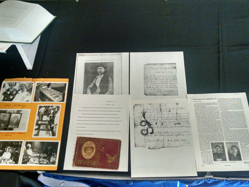Ned, Louise, and Marie reviewing memorabilia